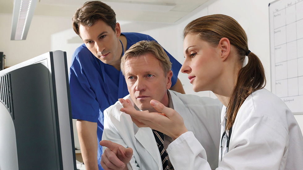 Download image (.jpg) (opens in a new window) Two doctors reviewing mammogram case